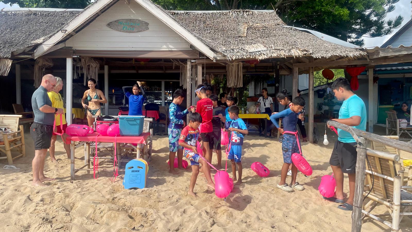 Children and volunteers preparing for a Sunday beach session outside the clubhouse