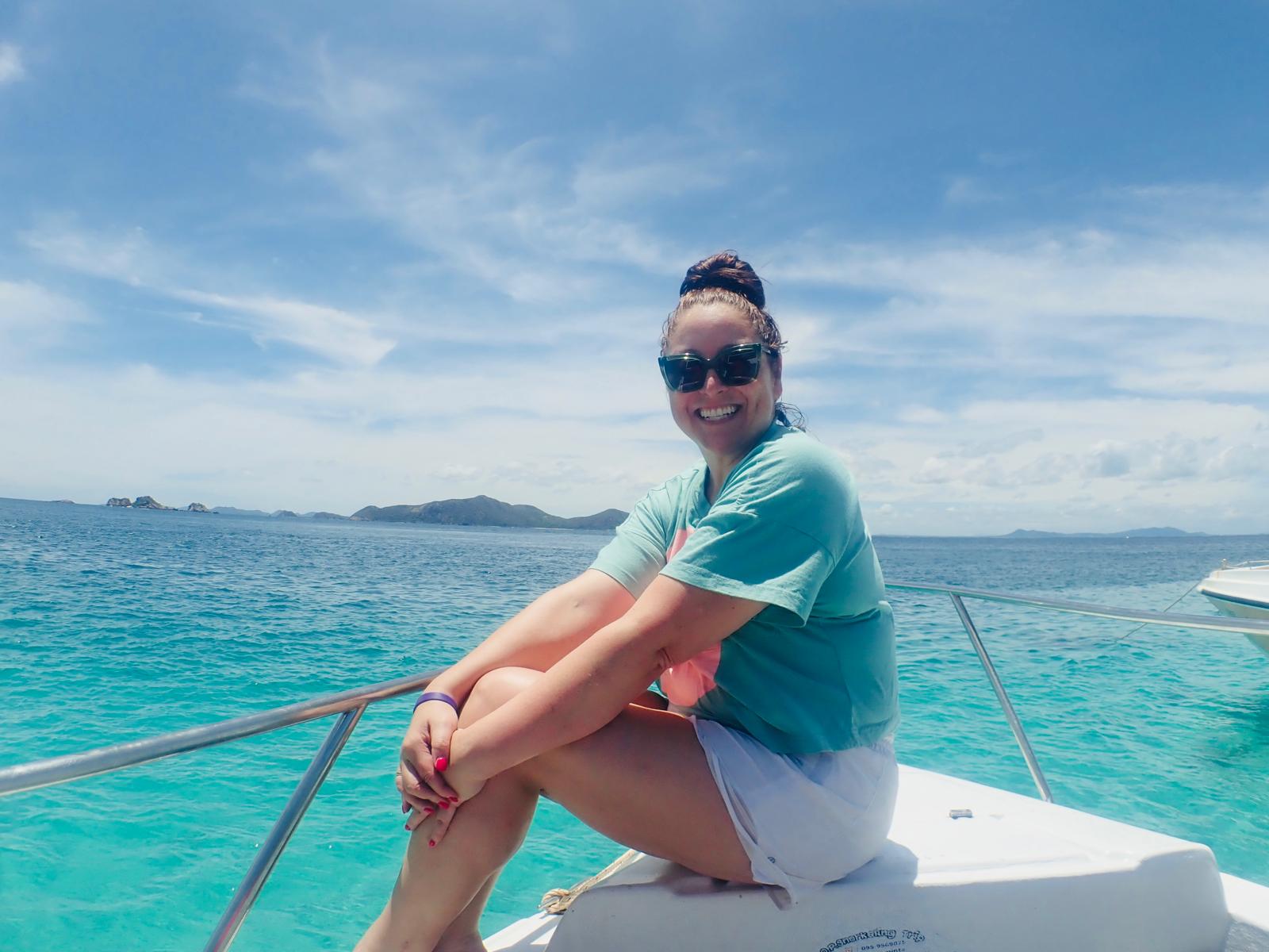 Amy sitting on a boat