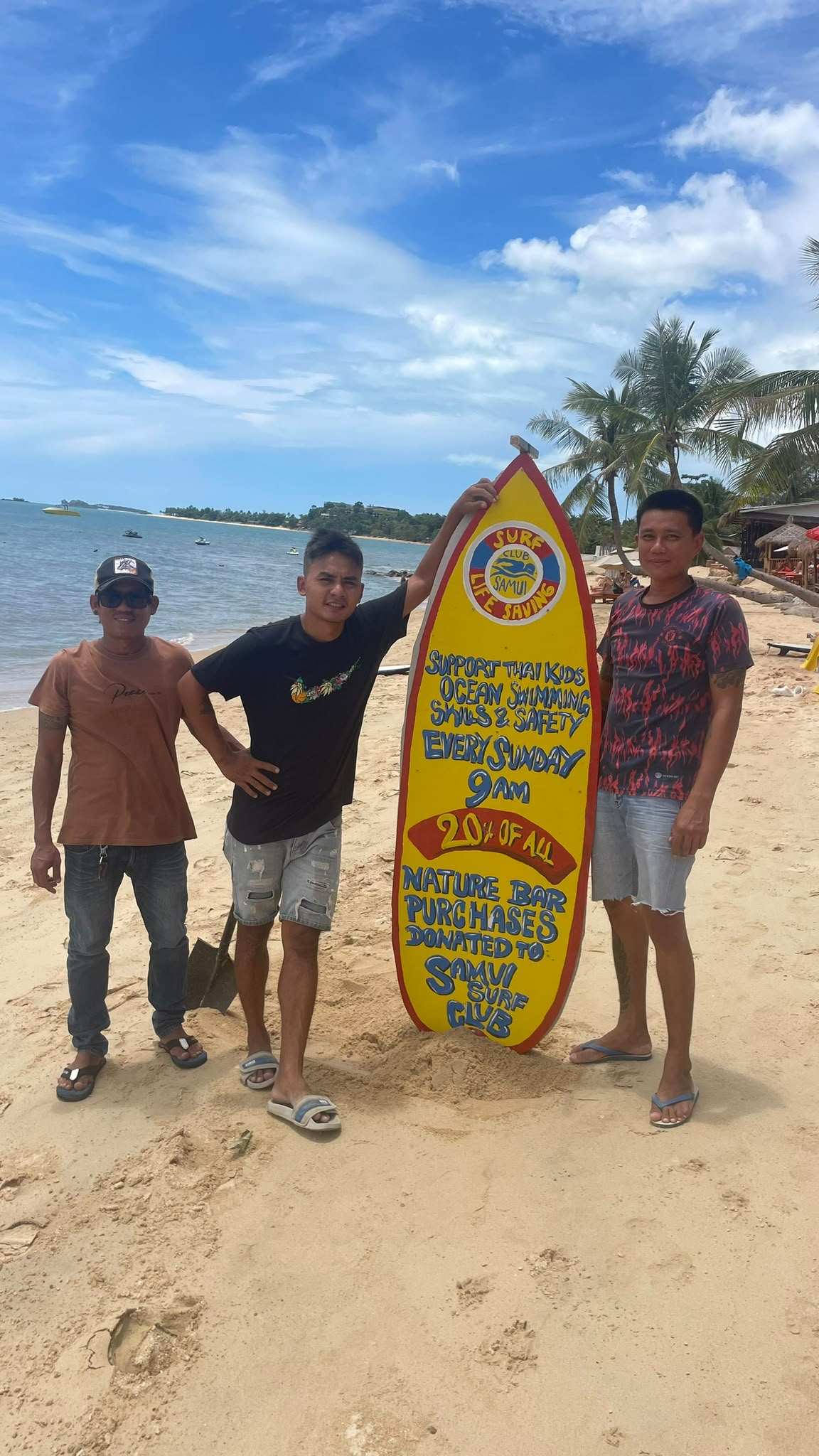 Myatt and Alex installing a beach sign